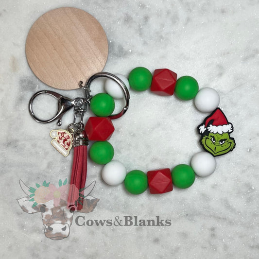 CHRISTMAS: YOU'FRE A MEAN ONE, MR.GRINCH! SILICONE BEADN WITH WHITE, RED AND GREEN ACCENTS BEADED STRETCH WRISTLET AND BRACELET WITH WOODEN DISC, RED TASSEL AND GRENCH CHARM