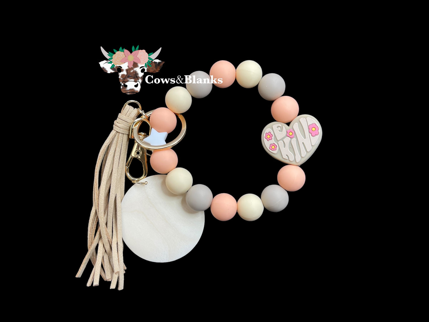 Be Kind!  Peach, Tan, and Beige Silicone Stretch Beaded Wristlet.  One is a White Star Accent Bead and the Other is a Tan "Be Kind" Heart Silicone  Bead with Gold Hardware, a Matching Tassel,  and a Wooden Disc