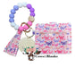 Wallet/Wristlet with Butterflies Covering the Cardholder With a Coordinating Silicone White, Pink and Purple Wristlet with Wooden Disc and Matching Tassel