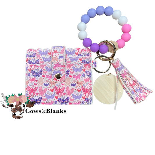 Wallet/Wristlet with Butterflies Covering the Cardholder With a Coordinating Silicone White, Pink and Purple Wristlet with Wooden Disc and Matching Tassel