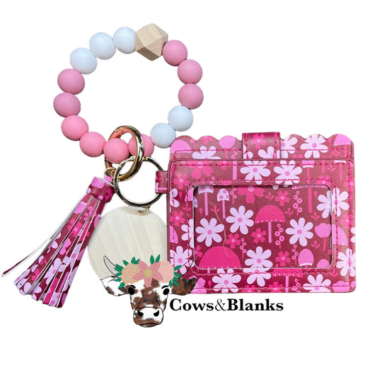 Wallet/Wristlet with Dark Pink and Contrasting Pink Flowers and Mushrooms Cardholder with a White, LIght Mauve, and Mauve Pink Silicone Beaded Wristlet with a Wooden Accent Bead, Gold Hardware, Matching Tassel, and a Wooden Disc