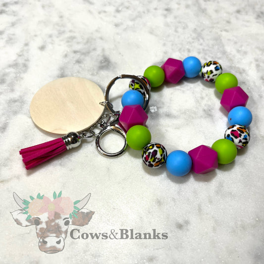 Lisa Frank Style Silicone Beaded Stretch Wristlet Bracelet Keychain with Wooden Disc and Tassel