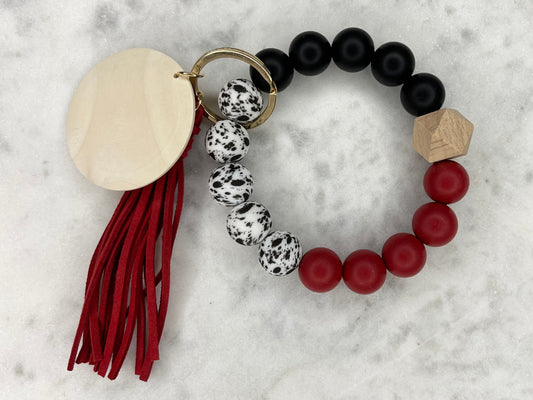 Cow Themed Red and Black Silicone Stretch Wristlet Bracelet Keychain with Wooden Disc and Tassel