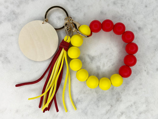 Yin and Yang Red and Yellow Silicone Stretch Wristlet Bracelet Keychain with Wooden Disc and Tassel